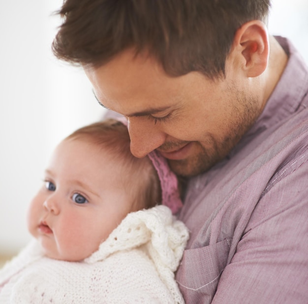 Photo family baby and dad at home with love support and care together with parent and bonding relax father and happy in a house with hug of a calm infant with childcare and smile with a young girl