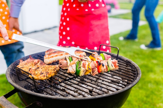 Family barbecue together in garden home