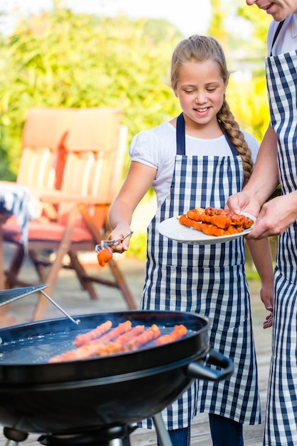 family barbecue together on terrace