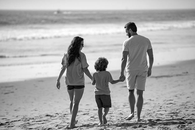 Family on the beach people having fun on summer vacation father mother and child holding hands again