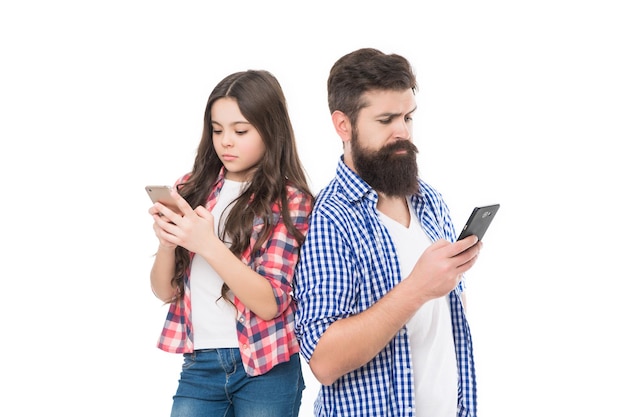 Family of bearded man father and girl child daughter look at mobile phones isolated on white smartphone addiction