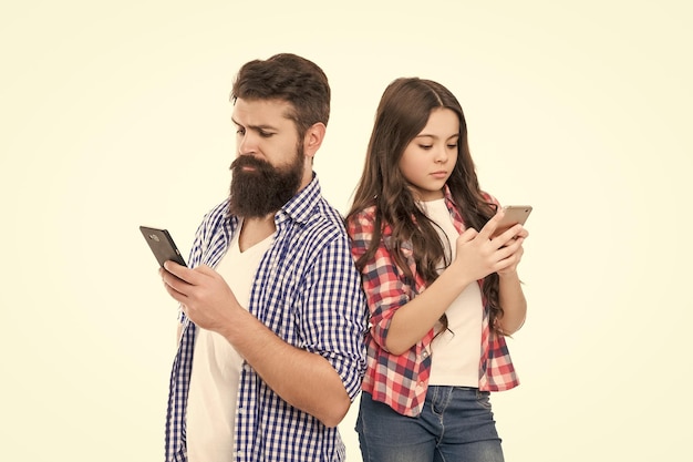 Photo family of bearded man father and girl child daughter look at mobile phones isolated on white smartphone addiction