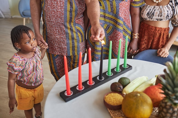 Family burning candles for Kwanzaa holiday