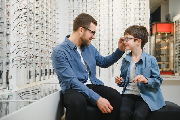 Family buy glasses Father in a blue shirt