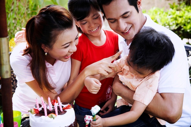 Family celebrating birthday in lawn