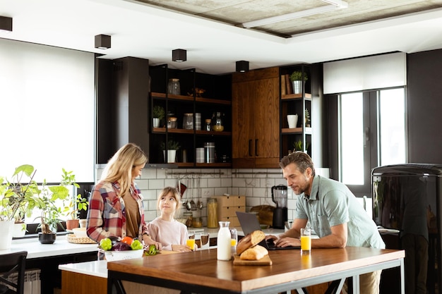 family chatting and preparing food around a bustling kitchen counter filled with fresh ingredients and cooking utensils