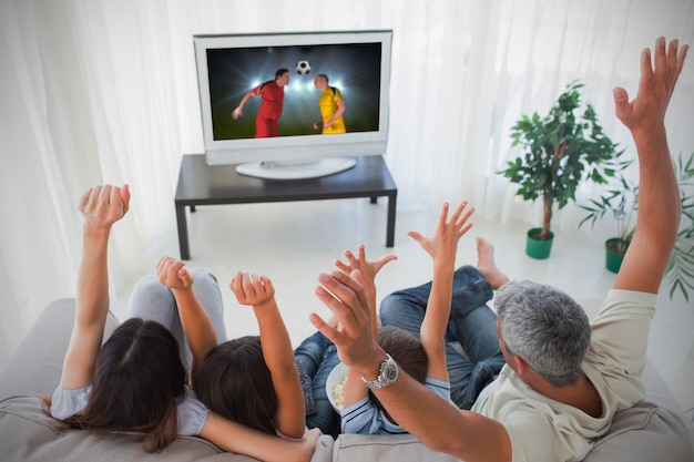 Photo family cheering and watching the world cup at home