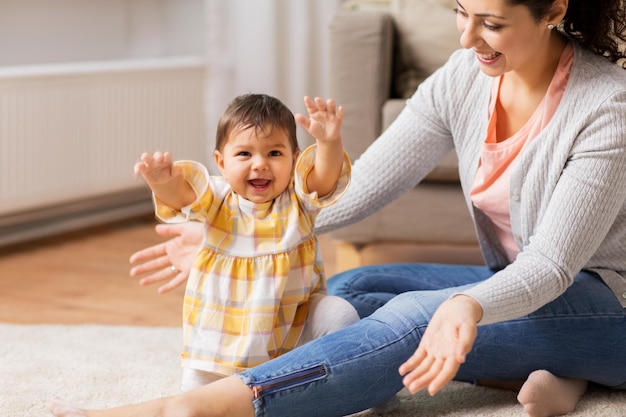 family child and motherhood concept happy smiling mother with little baby daughter at home