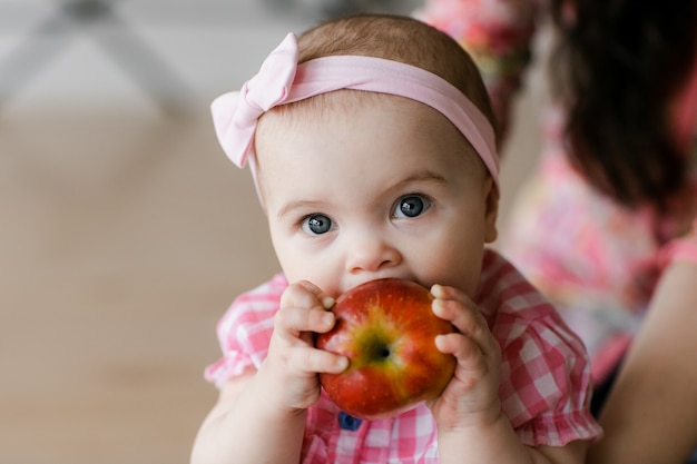 Photo family, childhood and parenthood concept - happy little baby learning to walk with mother help at home