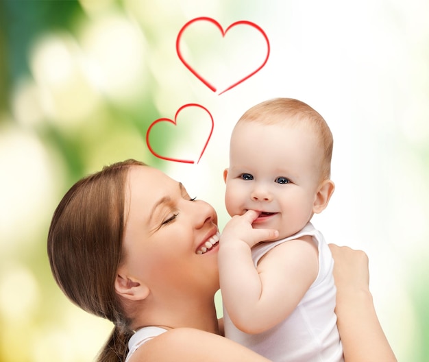 family, children, parenthood and happiness concept - happy mother with adorable baby