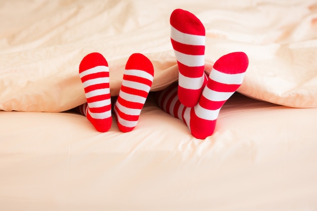 Family in Christmas socks lying on bed