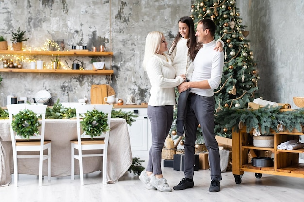 family, christmas, x-mas, winter, happiness and people concept - smiling family Preparing to celebrate Christmas.