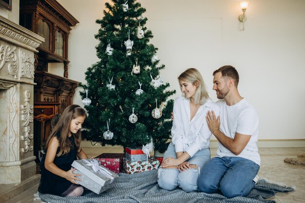 Family christmas xmas winter happiness and people concept happy\
family opening gift box