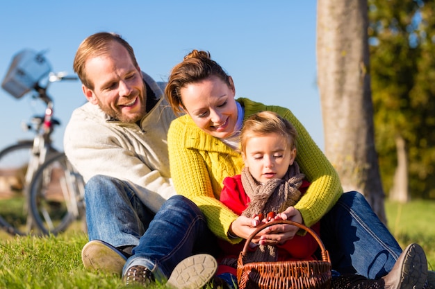 Family collecting chestnuts on bicycle trip