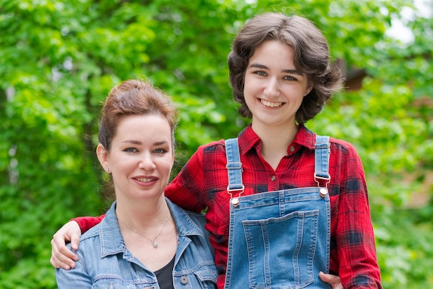 Family concept Daughter mother at home They both smiled happily in front yard