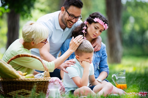 Family consoling little stubborn child and managing emotions outdoor