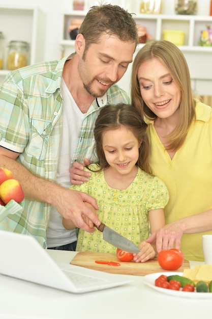 Family cooking together at kitchen table