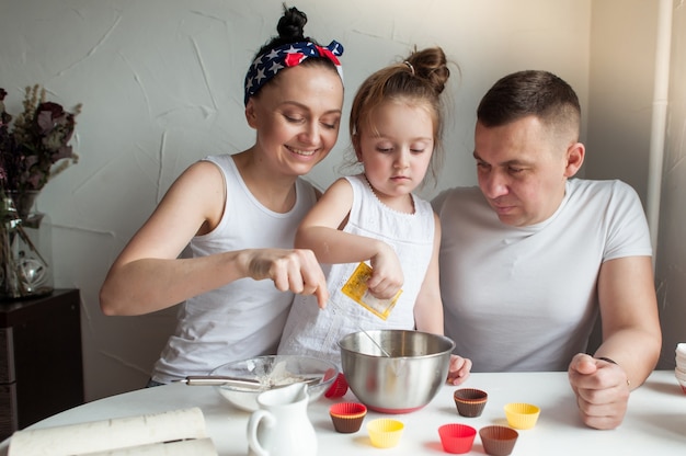 The family cooks cookies in the kitchen