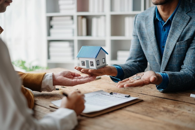 A family couple sign a lease meeting with a realtor or homeowner purchase the first mortgage and mortgage ownership conceptxA