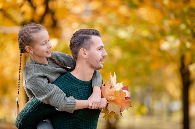 Family of dad and kid on beautiful autumn day in the park