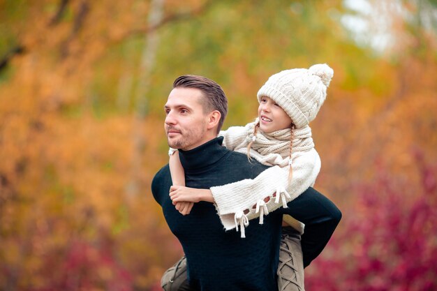 Family of dad and kid on beautiful autumn day in the park