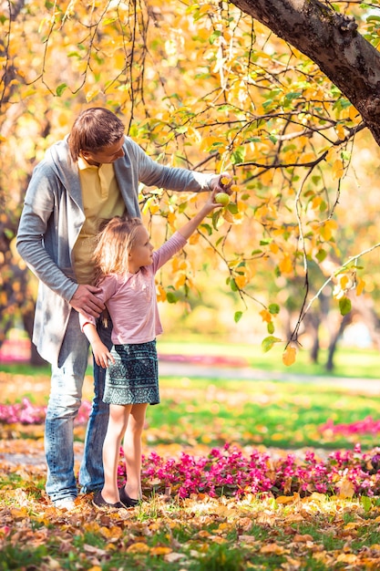 Family of dad and kid on beautiful autumn day in the park