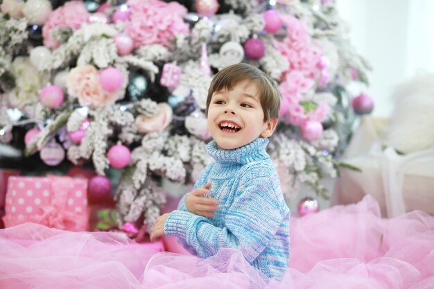 Family decorating beautiful live Christmas tree Loving family with presents in room