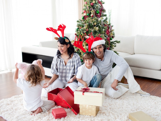 Family decorating a Christmas tree