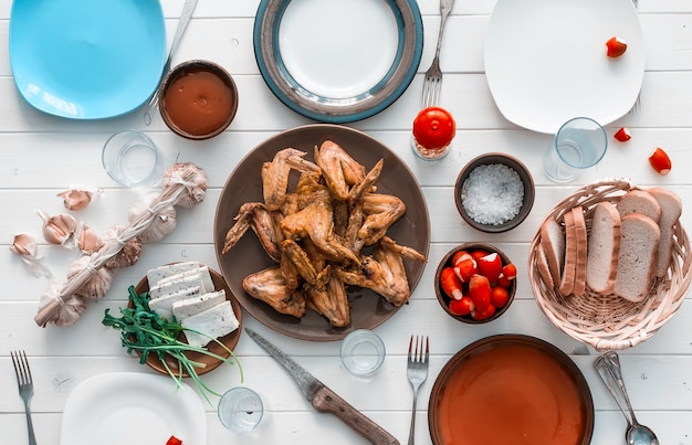 Family dinner with roasted chicken wings