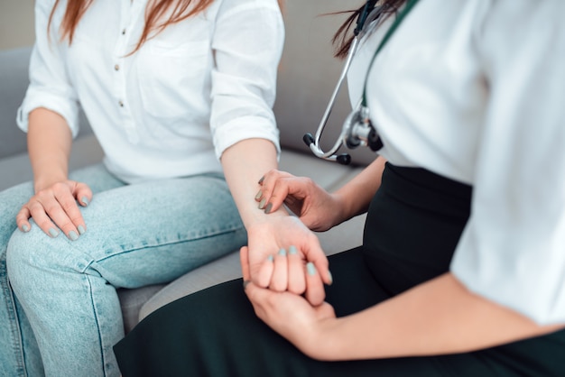 Family doctor check heart rate of a young mother