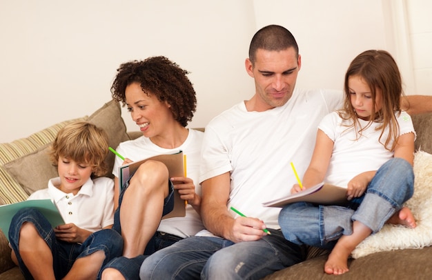 Family drawing togethe on the couch