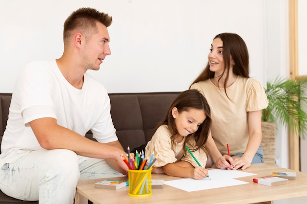 Photo family drawing together in the living room