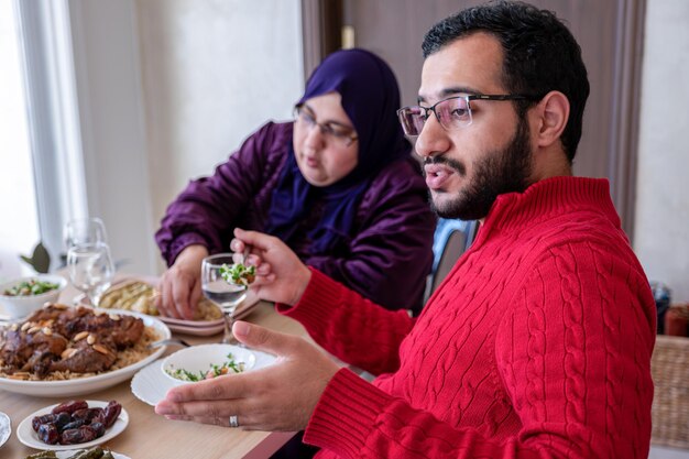 Family eating together with multi generation members in modern living room