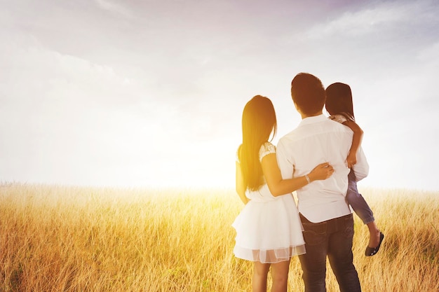 Family embracing each other while look at sunrise