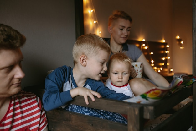 family evening before christmas reading a book and drink hot chocolate together