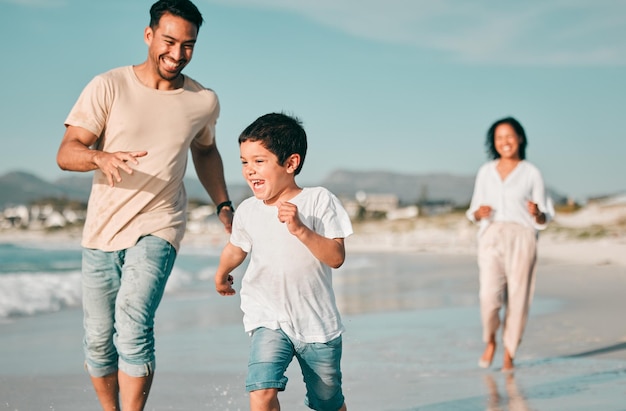 Family father and son running on beach with mother ocean and energy with bonding on holiday happiness and freedom Parents boy and carefree on tropical vacation in Mexico love and care outdoor