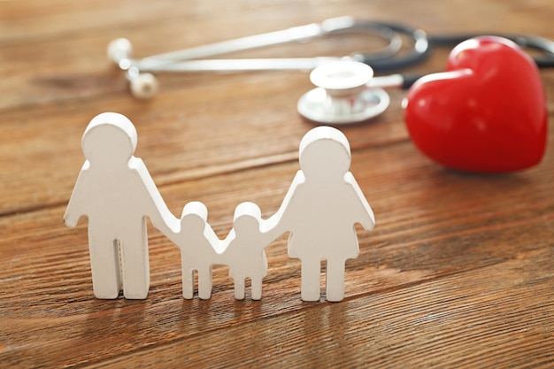 Photo family figure red heart and stethoscope on wooden background