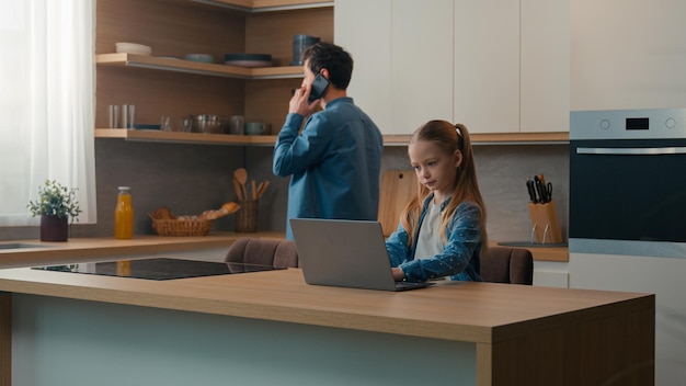 family food delivery medicine vegetarian healthy nutrition vitamins health kitchen man father bring two glasses orange fresh juice help daughter kid child girl with homework studying laptop elearning