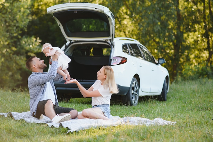 Photo family in a forest. people by the car. sunset background.