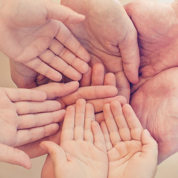 Family and friends concept Many human hands together top view