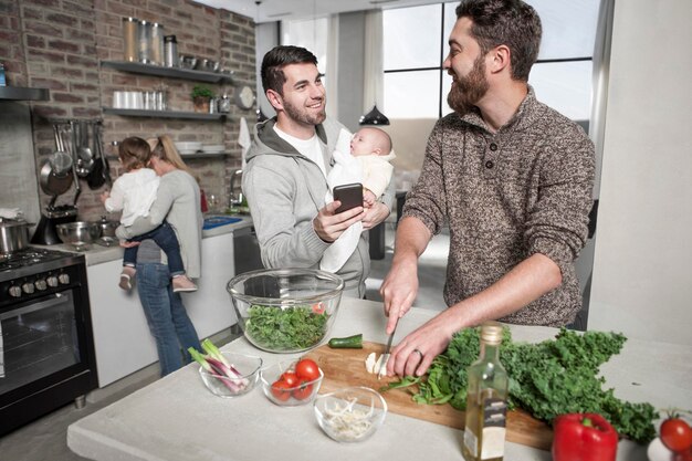 Family and friends preparing a healthy meal in kitchen