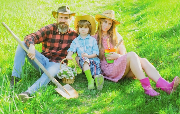 Family gardener in garden or park with shovel parenthood together leisure concept