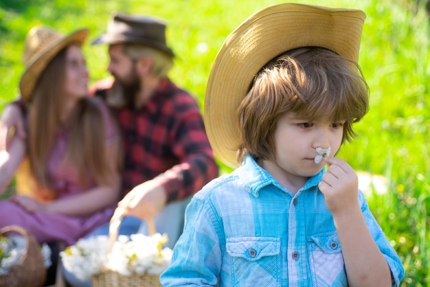 Family gardener on summer walk and picnic in garden or park. Parenthood together leisure concept.