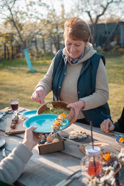 The family gathered at a festive table in the garden to celebrate easter