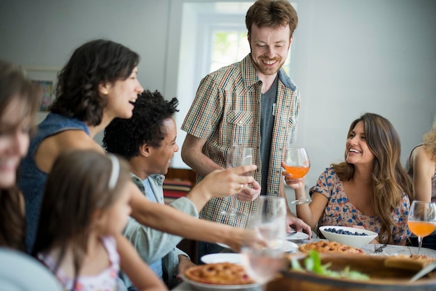 A family gathering for a meal Adults and children around a table