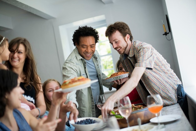 A family gathering for a meal Adults and children around a table