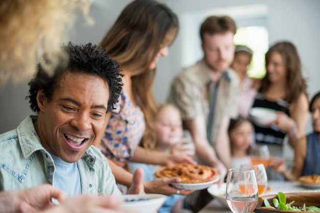 A family gathering for a meal Adults and children around a table