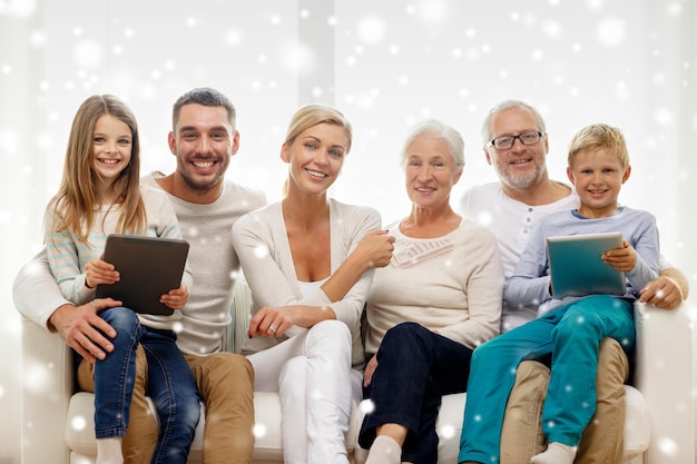 Photo family, generation, technology and people concept - smiling family with tablet pc computers at home