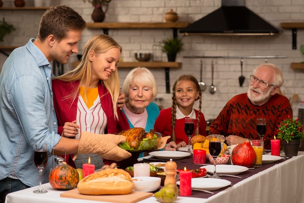 Photo family generations smelling the fresh cooked turkey