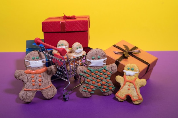 A family of gingerbread men in individual masks in a supermarket with gifts. Health and safety concerns